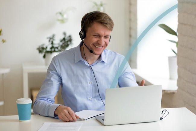 Man viewing a virtual meeting on a laptop