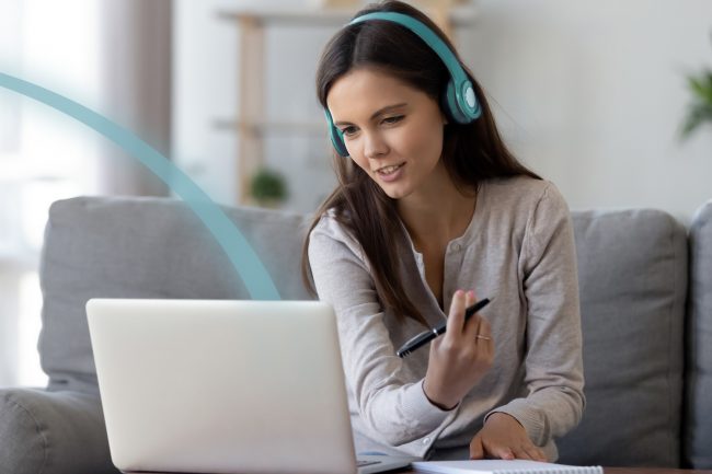 Lady engaging in a virtual meeting on a laptop working from home